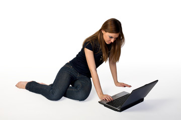Young woman sitting on floor using laptop © Sergios