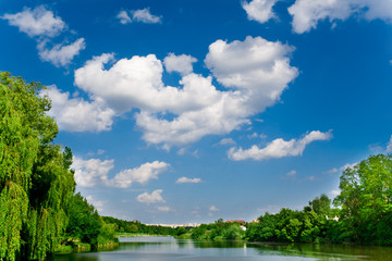 Obraz na płótnie Canvas blue sky with clouds over river