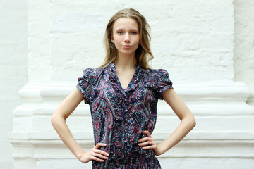 Beautiful woman standing against wall in background