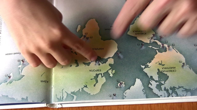 senior with child hands on map
