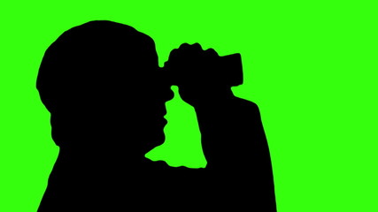Silhouette of man with binoculars against green screen - HD - Powered by Adobe