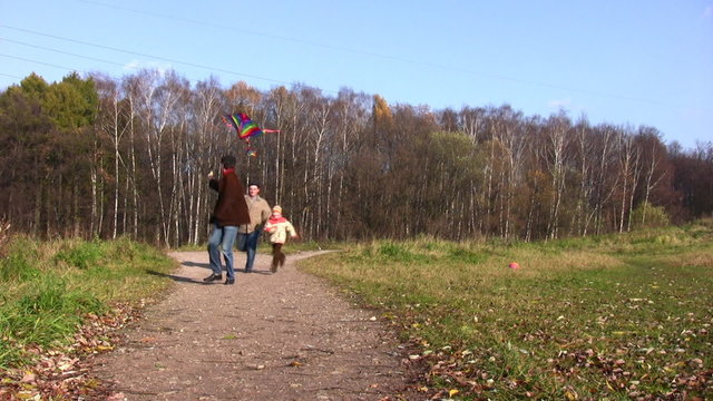 son, father and grandfather running with kite