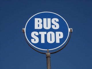 bus stop sign. Round shaped, against blue sky