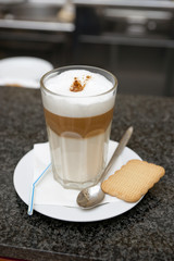 Glass of latte coffee on bar counter