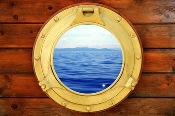 Boat closed porthole with vacation seascape view