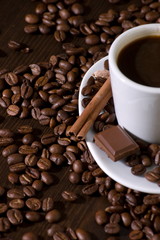 Cup of coffee with chocolate on coffee beans