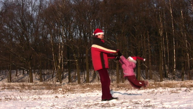 father rotating little girl in christmas hats