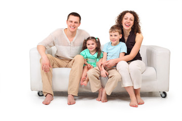 Family sitting on white leather sofa