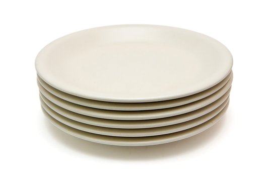 Stack Of Plain Beige Dinner Plates Isolated