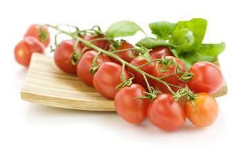Fresh tomatoes on wooden plate