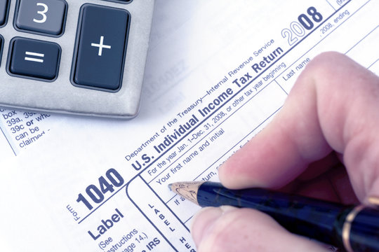 1040 Tax form with pen