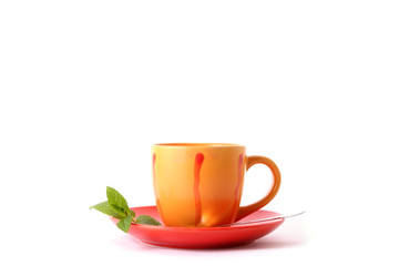 Cup of green tea on the saucer with mint