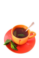 Cup of green tea on the saucer with mint