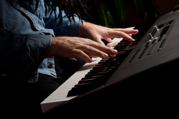 Fototapeta premium Male Pianist Performs on the Piano Keyboard