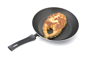 fried fish steak on griddle close up