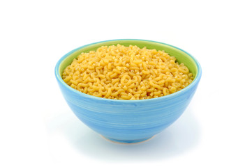 Macaroni in blue bowl isolated on white background