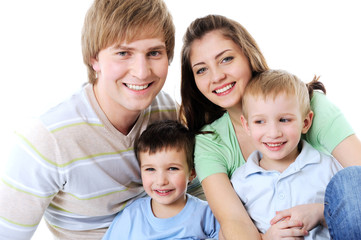 Obraz premium portrait of happy laughing young family with two sons
