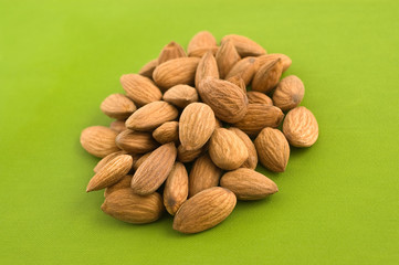 Group of almnonds on green background