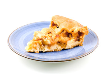 Piece of apple pie on blue plate isolated on white background