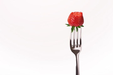 red strawberry on fork