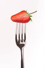 red strawberry on fork