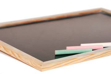 stick of color chalk on a blackboard isolated background