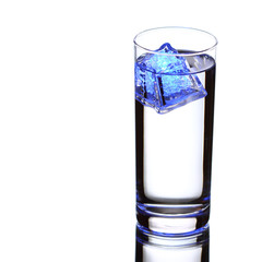 glass with water and blue ice isolated on white