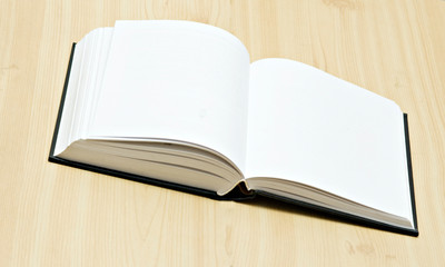 Open book on desk isolated on white background