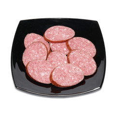 Sliced sausage on black plate