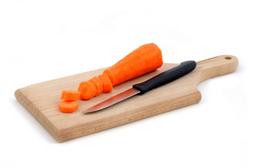 Sliced carrot on cutting board isolated on white background