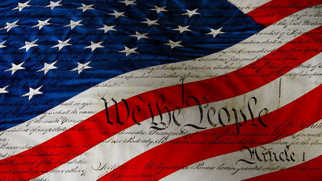 US flag waving, loop with fragments of the Constitution.