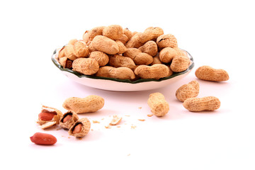 Few peanuts and dish isolated on white