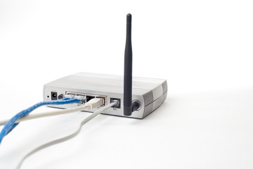 The back of a silver ADSL router with cables and