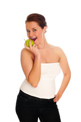 Young woman eating apple and smile over white background