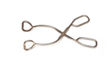 Metal tongs isolated on a white studio background.