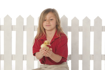 Girl with fence with duckling