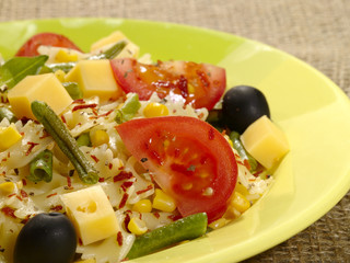italian pasta with string beans cheese and spices on the plate