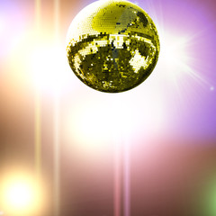 Gold disco ball with colored lights background