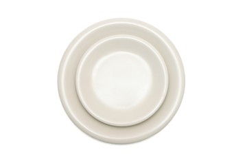 Plain beige dinner plate and  saucer isolated top view
