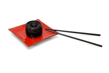 Fototapeta premium Objective lens on square plate and chopsticks isolated