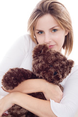 Young woman hugs her teddy bear
