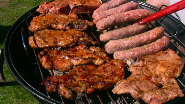 Chicken and steak cooking on a charcoal grill 1