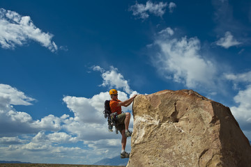 Fototapeta premium Rock climber nearing the summit.