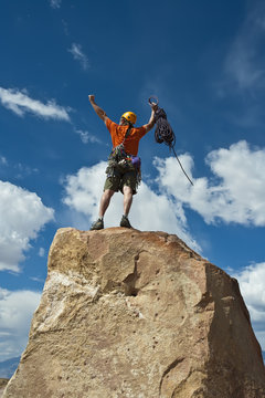 Rock climber nearing the summit.