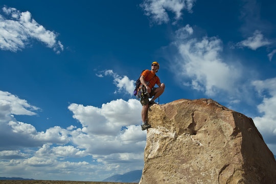 Rock climber nearing the summit.