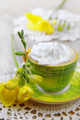 beverage with whipped cream and fresia flowers around