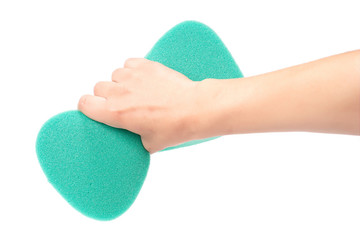 Woman's hand with green sponge for washing with round edges