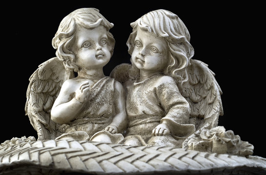 Two beautiful angels sitting