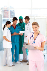 Nurse with colleagues in the background