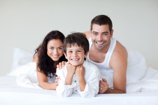 Happy family on bed enjoying together